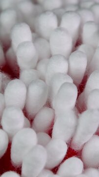 Vertical video cotton swabs rotating, cotton buds macro shot. Ear cleaning q-tips. Personal hygiene and cosmetic items