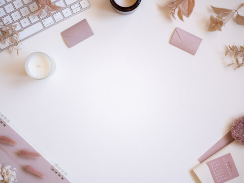 Pink and beige feminine workspace, pastel toned computer desk flat lay top view, text space