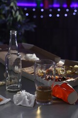 Messy table with beer and food leftovers indoors. After party chaos