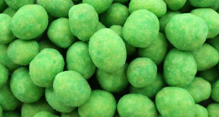 Tasty wasabi coated peanuts as background, closeup