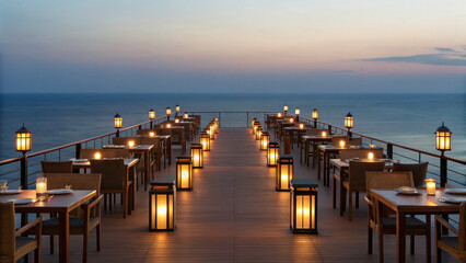 Obraz premium Seaside cliff restaurant tables lit by lanterns at sunset, creating romantic and serene atmosphere overlooking ocean
