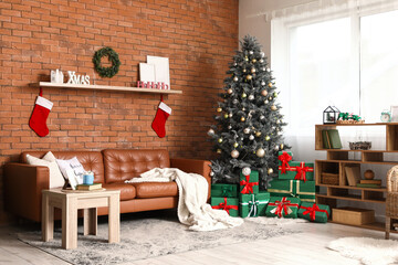 Interior of living room with Christmas tree, sofa and bookshelf
