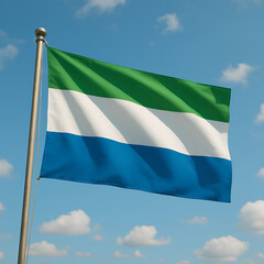 Sierra Leone’s green, white, and blue flag waves under a bright blue sky.