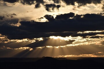 araffes in the sky with sun rays coming through the clouds