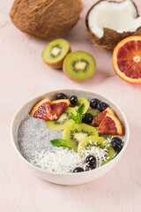 Healthy breakfast bowl with chia pudding on coconut milk, kiwi, blood orange, and berries