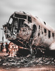 Damaged airplane wreckage, littered ground