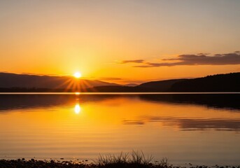 Obraz premium Sunset Over Calm Lake Vibrant Orange Sky Reflection Peaceful Natural Scene