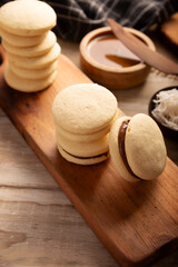 Alfajores. A traditional cookie popular in Latin American, it consists of two cookies joined together with dulce de leche forming a sandwich, covered with powdered sugar, grated coconut or chocolate.