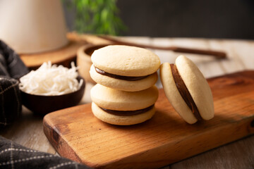 Alfajores. A traditional cookie popular in Latin American, it consists of two cookies joined together with dulce de leche forming a sandwich, covered with powdered sugar, grated coconut or chocolate.