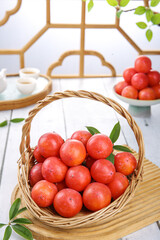 Fresh Persimmons in Wicker Basket on Kitchen Table with Natural Lighting