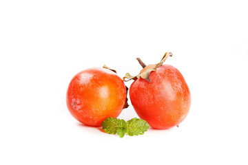 Fresh Ripe Persimmons with Mint Leaves Isolated on White Background