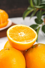 Fresh Navel Orange Set with Sliced Half Showing Juicy Interior and Green Leaves