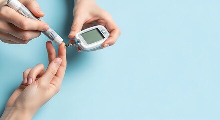 Close-up of a person using a glucose meter to check blood sugar levels on a light blue background.