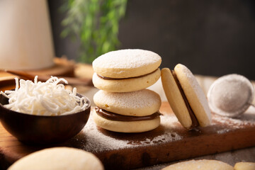 Alfajores. A traditional cookie popular in Latin American, it consists of two cookies joined together with dulce de leche forming a sandwich, covered with powdered sugar, grated coconut or chocolate.