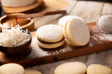 Alfajores. A traditional cookie popular in Latin American, it consists of two cookies joined together with dulce de leche forming a sandwich, covered with powdered sugar, grated coconut or chocolate.