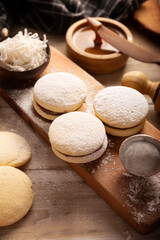 Alfajores. A traditional cookie popular in Latin American, it consists of two cookies joined together with dulce de leche forming a sandwich, covered with powdered sugar, grated coconut or chocolate.