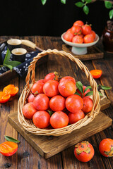 Fresh Shanxi Persimmons in Wicker Basket - Traditional Chinese Fruit Display on Rustic Wood Table