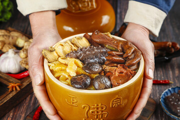 Traditional Chinese Herbal Soup Bowl with Mushrooms and Health Ingredients Held by Hands