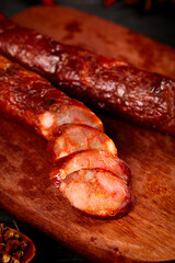 Homemade Sichuan Smoked Sausage Slices on Wooden Board - Traditional Chinese Spicy Cured Meat