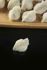 Traditional Handmade Pork Dumplings on Wooden Board Ready for Cooking