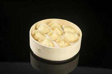 Traditional Handmade Pork Dumplings in Bamboo Steamer Basket Asian Cuisine