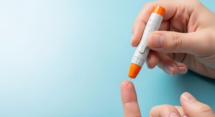 Close-up of a person's hand using a lancet device to prick their finger for a blood glucose test.