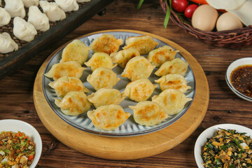 Traditional Handmade Pork Dumplings with Dipping Sauce on Wooden Table