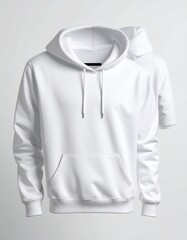 Two plain white hooded sweatshirts, one slightly blurred in the background, are posed on a white backdrop, emphasizing the texture and design