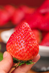 Fresh Red Strawberry Held in Hand - Ripe Fruit Close-Up with Natural Light