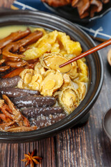Chinese Hot Pot with Abalone and Sea Cucumber in Traditional Ceramic Bowl