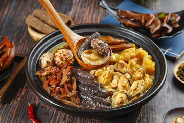 Buddha Jumps Over Wall Chinese Supreme Soup with Mushrooms and Seafood in Traditional Black Bowl
