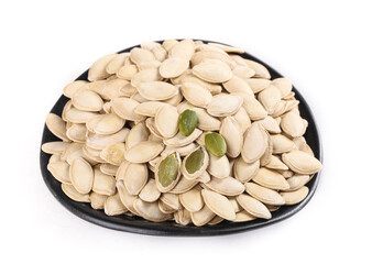 Pumpkin Seeds in Black Bowl on White Background - Healthy Snack and Cooking Ingredient