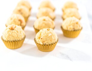 Creamy, nut-filled truffles in gold cups