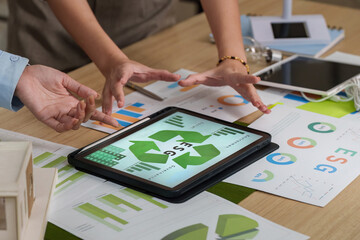 Collaborative ESG Discussion. Team analyzing Environmental, Social, and Governance data on a tablet.