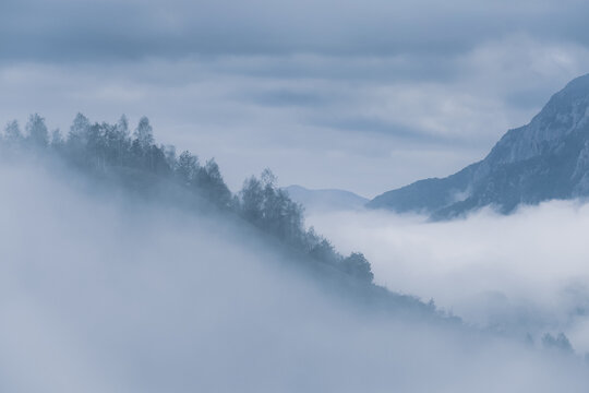 Cloudy sky and morning fog over the hills and mountains.