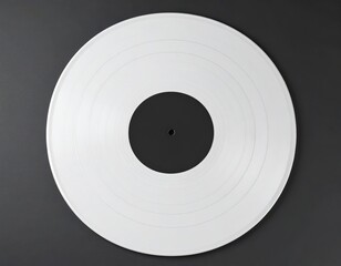 A pristine white vinyl record with concentric grooves sits on a dark gray surface, top view. Centered composition highlighting simplicity and texture