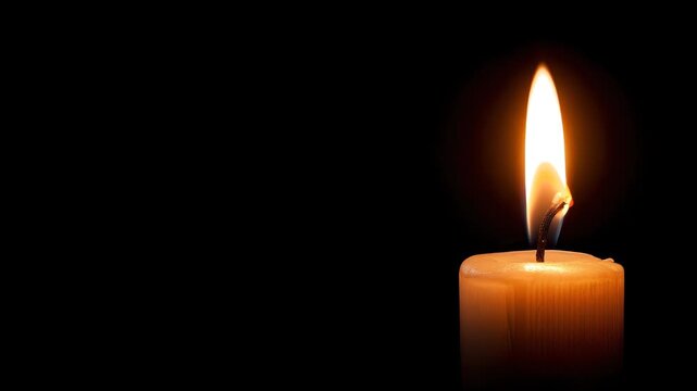 Candle flame burning steadily in darkness with warm light glow from wax wick fire creating calm peaceful atmosphere symbolizing resilience and hope