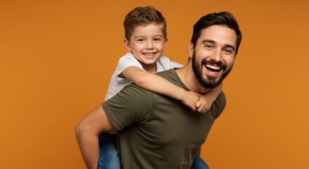 Cheerful father and son piggybacking in studio capturing a happy family moment