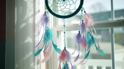 Colorful dreamcatcher hanging by a window, adorned with feathers and ribbons, capturing sunlight - Powered by Adobe