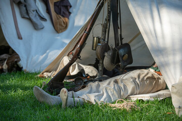 A soldier rests in his tent during a Civil War re-enactment
