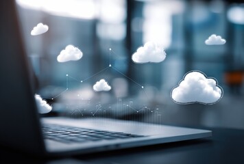 Laptop with cloud graphics overlays depicting connectivity, data, and modern digital workspace against an unfocused, blurred background