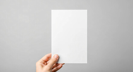 Hand Holding Vertical White Card on Gray Background