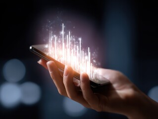A hand holds a smartphone displaying glowing data visualizations, symbolizing technology and digital communication in a modern context.