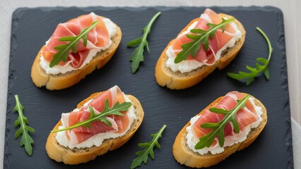 Elegant Italian crostini with prosciutto, cream cheese, and arugula served on slate plate, styled for fine dining stock photography.