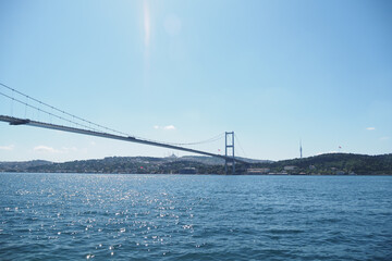 Iconic bridge spans across water in a bright, sunny day