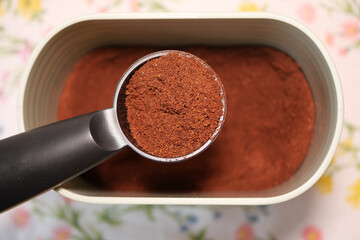 Freshly ground coffee ready for brewing in a container