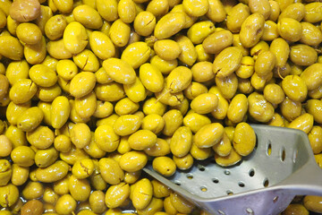 Fresh yellow olives displayed in a market stall