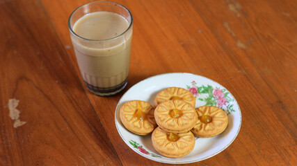 Breakfast and snack menu. Butter biscuits with pineapple jam and a glass of chocolate milk. Close-up of butter cookies and a glass of chocolate, sweet cakes. Perfect for recipes, articles, catalogs.