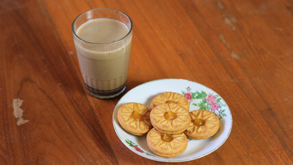 Breakfast and snack menu. Butter biscuits with pineapple jam and a glass of chocolate milk. Close-up of butter cookies and a glass of chocolate, sweet cakes. Perfect for recipes, articles, catalogs.