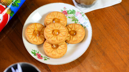 Breakfast and snack menu. Butter biscuits with pineapple jam and a glass of chocolate milk. Close-up of butter cookies and a glass of chocolate, sweet cakes. Perfect for recipes, articles, catalogs.